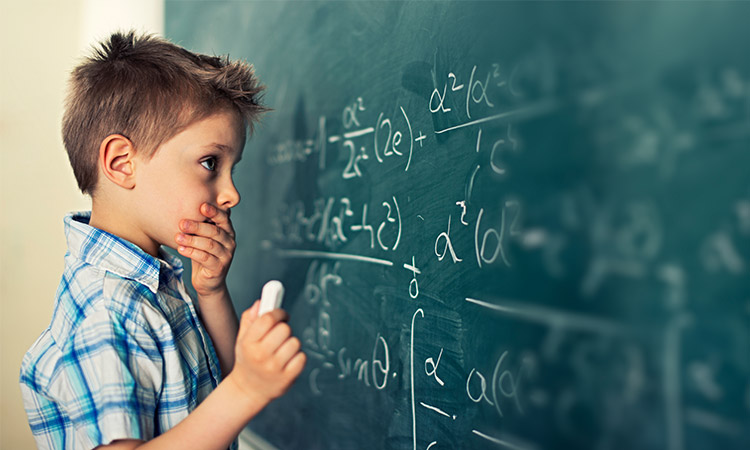 Boy writes on a blackboard (photo)