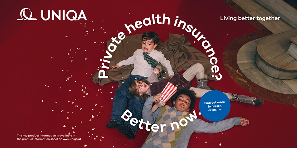 Three children lying on the floor with popcorn.
