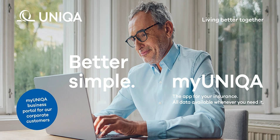 myUNIQA app advertising campaign: in the background, a man with glasses working on a laptop at home.
